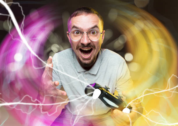istock Enthusiastic gamer. Joyful young man holding a video game controller 1172739590