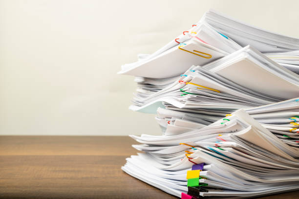 istock Stack of vintage document paper with colorful paperclip. 1172739605