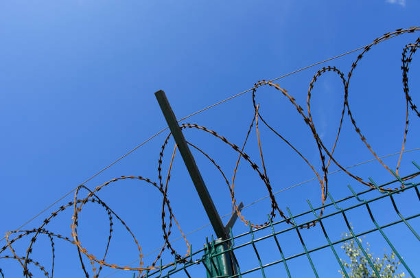 istock Coils of razor wire with a crossbar 1172744097