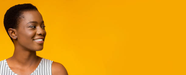 istock Cheerful young black woman looking aside at empty space 1172744816