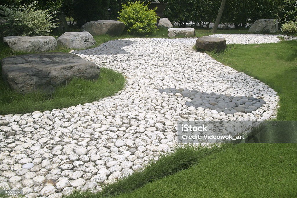 Zen garden A stone walkway through an Japanese garden Backgrounds Stock Photo