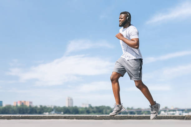 istock Afro Guy Running Working Out Near River In City 1172745524