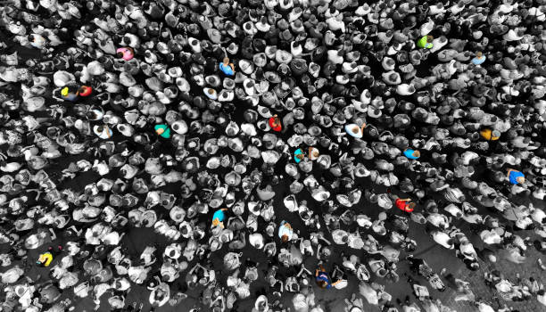 special people amid the crowd concept with colorful persons amid the monochrome people. top view from drone. - specific imagens e fotografias de stock