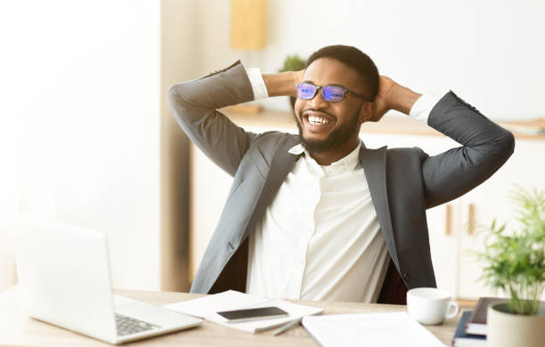 istock Black businessman resting in office, leaning back in chair 1172745718
