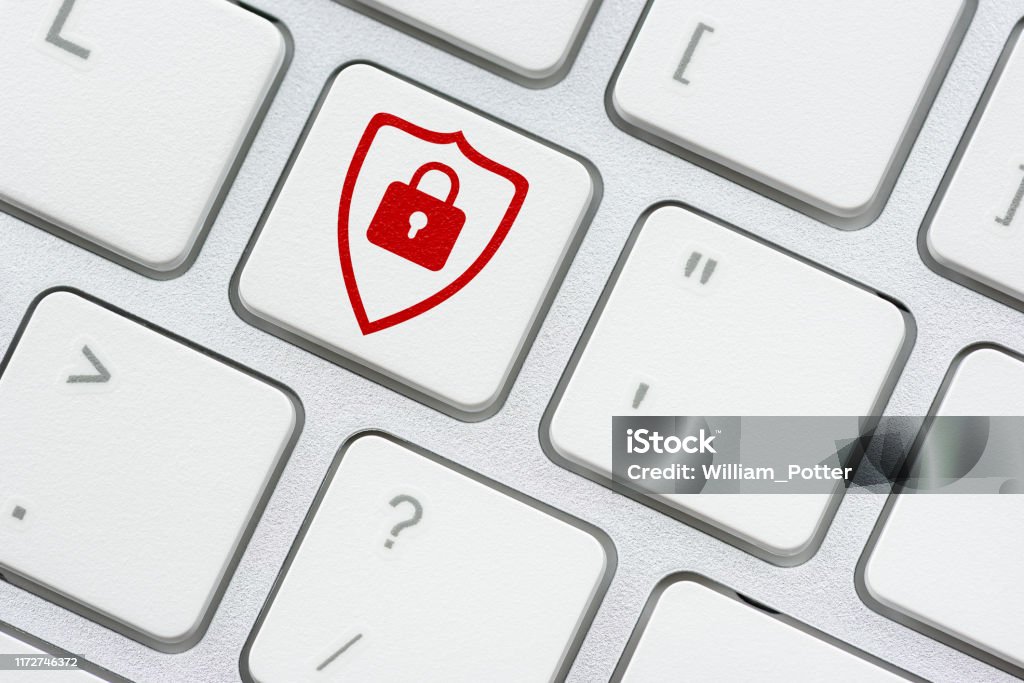 Cyber crime and cyber security concept : Red shield and a pad lock on computer keyboard button, depicts protection and prevent cyber attack from attacker or a hacker who attempt to access on a system Security Stock Photo