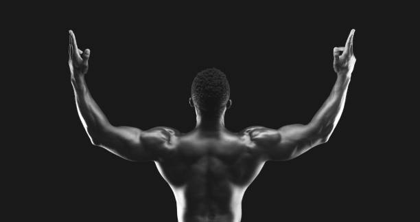 istock Rear view of black athlete raising hands up 1172746763