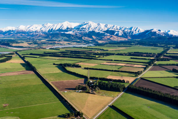 An elevated view of the farmlands of the Canterbury Plain, on New Zealand's South Island, stretching away towards the mighty Southern Alps.
