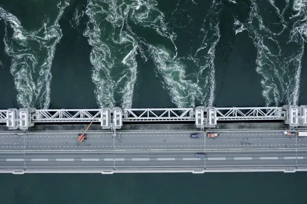 A storm surge barrier in the Netherlands venting water to ease flooding risks to the country after heavy rains and high tides