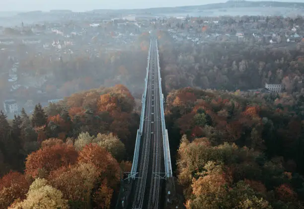 A railway track crossing a bridge on a foggy morning in Germany