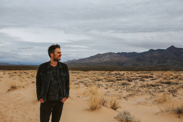 istock young man walking through the Mojave desert 1172751548