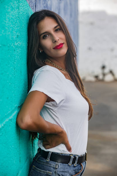 istock Pretty young female leaning on wall outdoors 1172756931