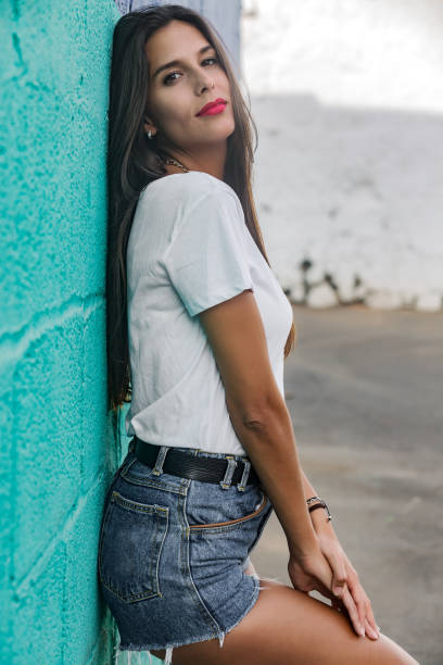 istock Sensual pretty woman leaning on bright wall 1172756951