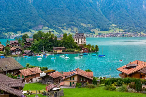 Aerial view of the peninsula and former castle and Lake Brienz in swiss village Iseltwald, Switzerland