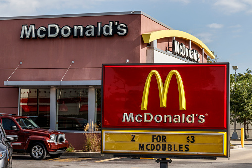A large McDonald's with a drive through and a Ronald McDonald gym