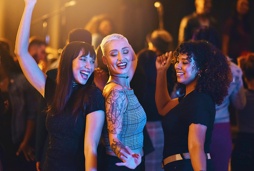 Cropped shot of a group of attractive young girlfriends dancing at a party in a nightclub