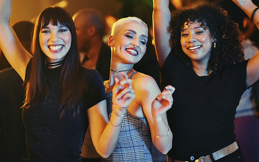 Cropped shot of a group of attractive young girlfriends dancing at a party in a nightclub