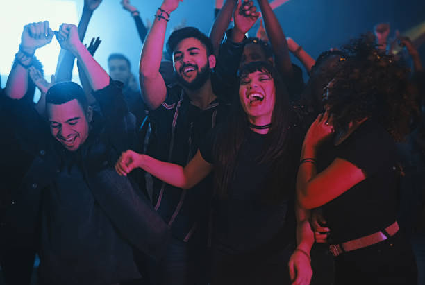 This is how we do! Cropped shot of a group of energetic young friends dancing at a party in a nightclub concert stock pictures, royalty-free photos & images