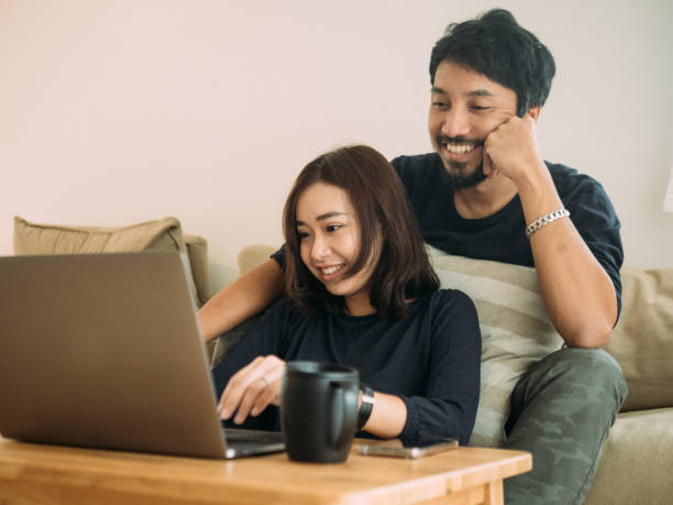 istock Young couple working at home with laptop. 1172761722