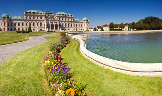 The grand and imposing Belvedere Palace in Vienna.  The gardens are executed in classic French style and are in full bloom in this summer scene.  Stitched panorama highly detailed when viewed.