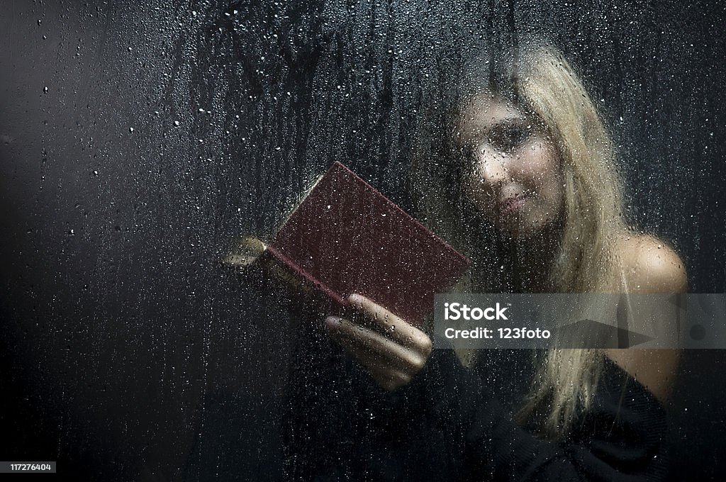 Rainy Night Woman behind wet window. Adolescence Stock Photo