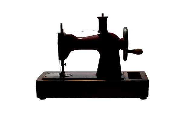 istock Silhouette of a retro sewing machine with a spool of thread 1172765880