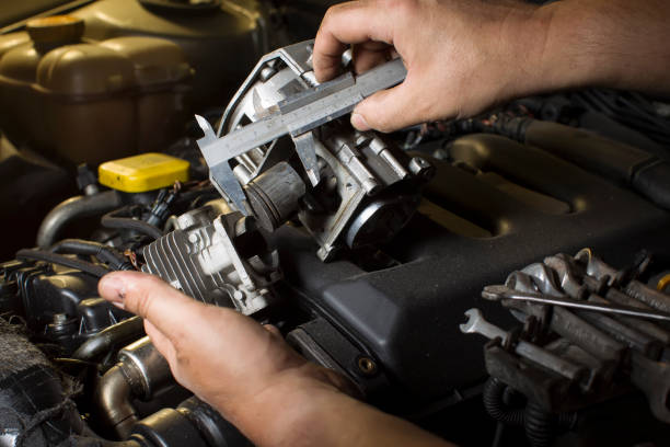 istock Hands measure the piston of a car engine using a ruler 1172765893