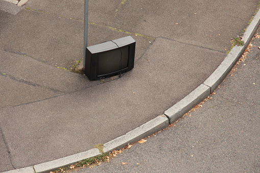 abandoned TV on the walkway