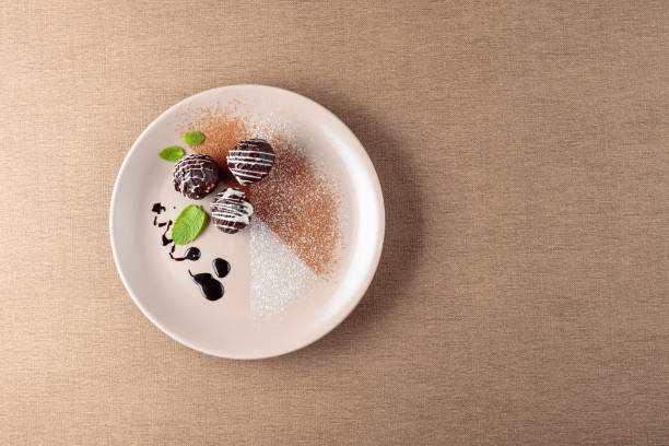 istock Chocolate balls with mint on a beige plate. 1172767918
