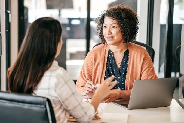 Two women discussing strategy