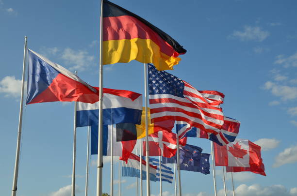 Different nations flags together in the sky Multiple flags of different nations caen photos stock pictures, royalty-free photos & images