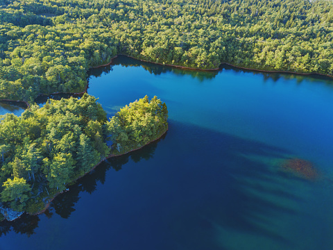 Aerial drone view of a reservoir lake with very clear water.