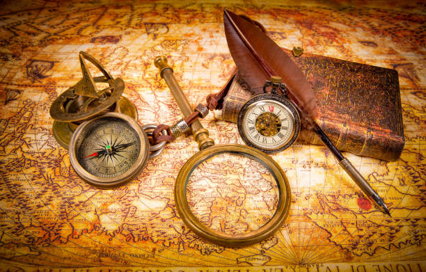Vintage magnifying glass, pen, book, compass, pocket watch. Map of the Ancient World in 1565. stock photo