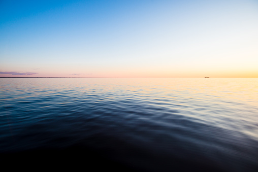 Baltic Sea at sunset. Pure evening sunlight and reflections on the water. View from the yacht. Latvia