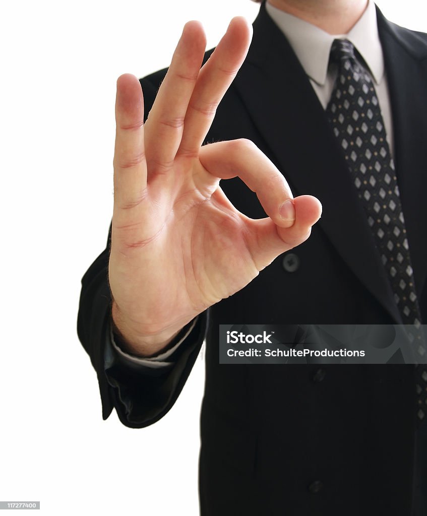 OK Good Job a business man giving a ok sign isolated on white. Achievement Stock Photo