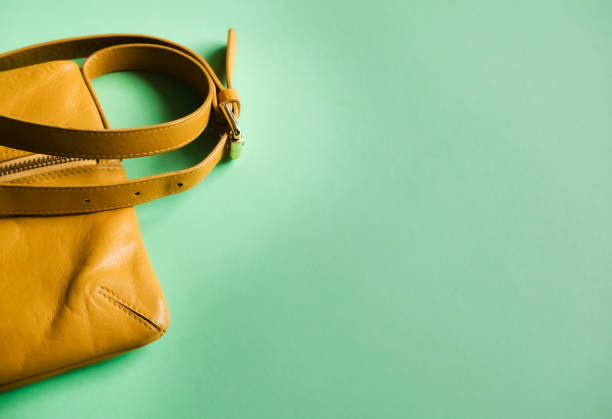 istock Mustard leather bag on mint green. 1172774425