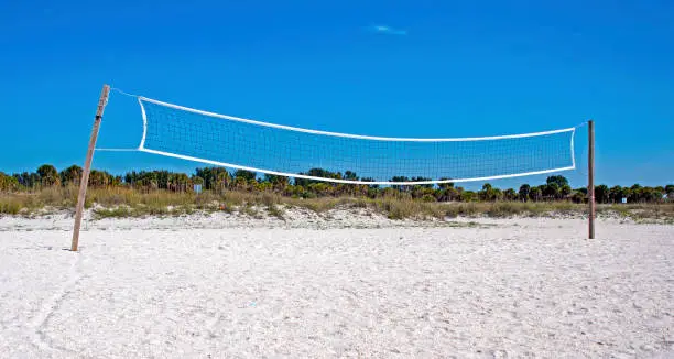 Beach volleyball court and net, on a sunny warm summer morning. Clearwater Beach, Florida, USA