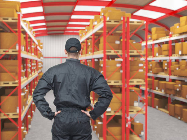istock Rear View Of Man Standing With Hands On Hip In Warehouse 1172778855