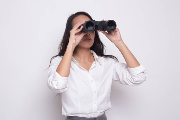 istock Young Asian woman with binoculars. 1172780496