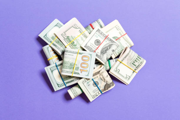 istock US Dollar bills bundles stack. one hundred dollar bills with stack of money in the middle. Top view of business concept on background with copy space 1172782752