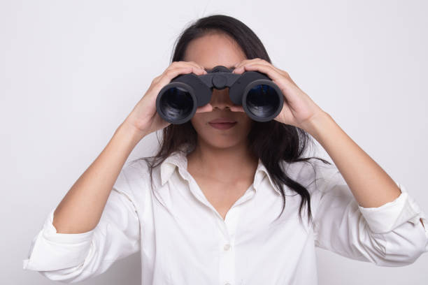 istock Young Asian woman with binoculars. 1172783094