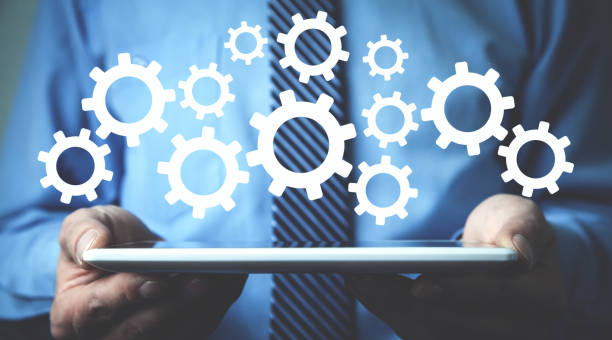 istock Man holding tablet with a gears mechanism. 1172788287