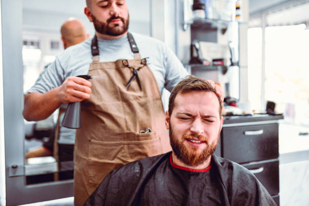 istock Barber Spraying Water On Customer's Hair 1172791384