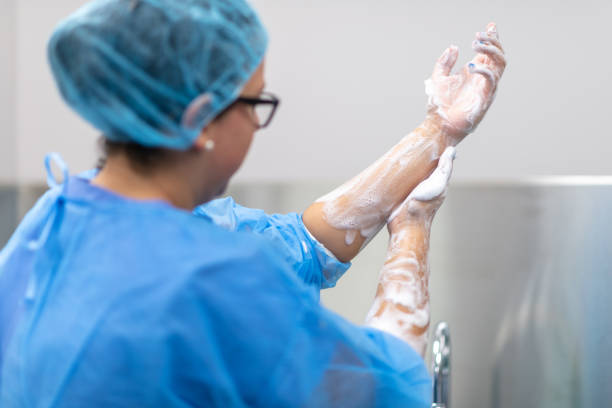 istock Female surgeon washes hands before performing operation 1172794935