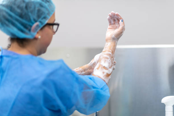 istock Female surgeon washes hands before performing operation 1172795032