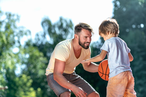 istock Dad and son playing basketball 1172795395