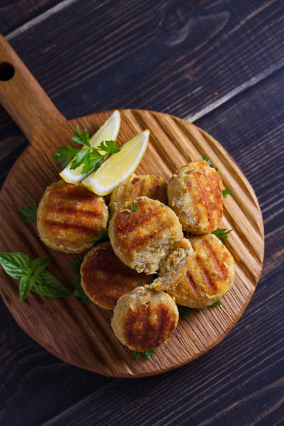 istock Fish cakes. Fish patties. Fried cutlets of minced fish on serving board 1172796251