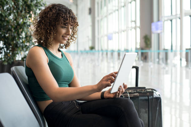 istock Young woman using digital tablet in airport 1172797974