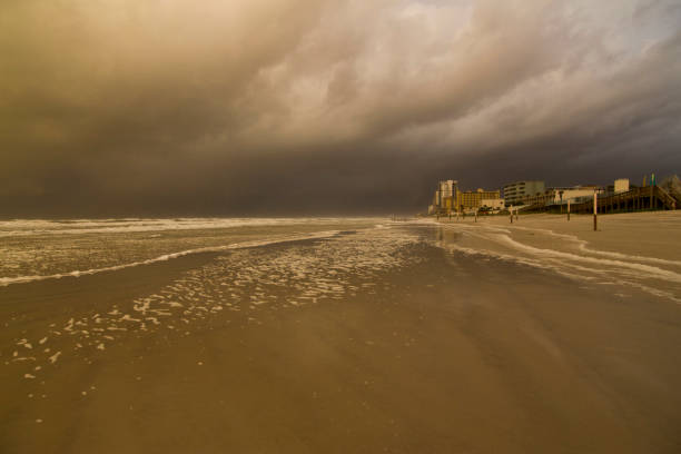 The color of clouds and sea, the shapes of waves and long exposure of clouds as hurricane dorian was passing by Daytona beach Florida USA tones of pink yellow and blue and the rage of the waves crashing on the beach