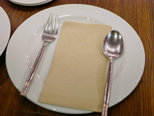 istock A prepared clean spoon, fork, and plate on a dining table for customers to come eat at the restaurant 1172800601