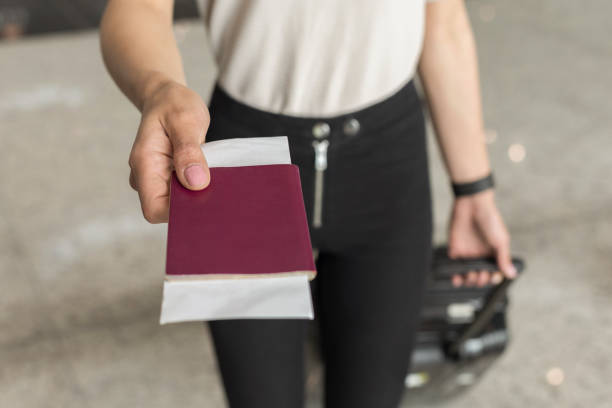 Young man holding in hand foreign passport